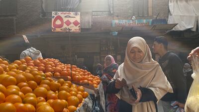 Noura Refaey, an Egyptian mother of three, at a food market in Cairo's Talbia where food prices continue to rise. Mahmoud Nasr / The National