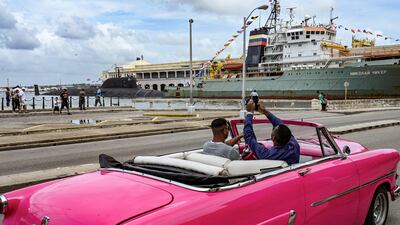 A man takes pictures of the nuclear-powered submarine Kazan and the rescue and salvage tugboat Nikolai Chiker, part of the Russian naval detachment visiting Cuba, after its arrival at Havana's harbour. AFP