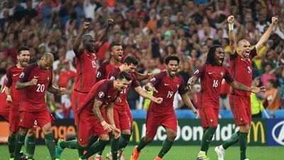 Portugal players celebrate after winning the penalty shootout. Anne-Christine Poujoulat / AFP