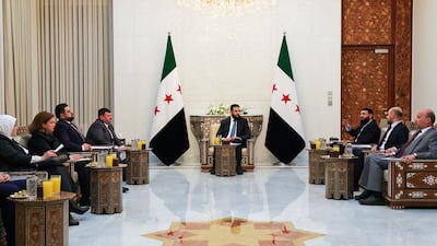 Ahmad Al Shara meets members of the new committee on Sunday in Damascus. AFP