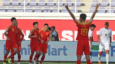 China's players celebrate after scoring their equaliser. AFP