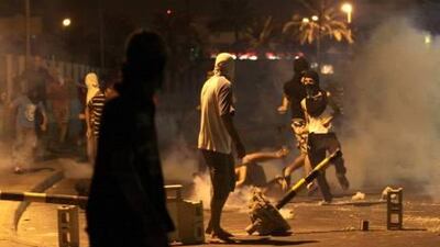 Anti-government protesters run from tear gas on Tuesday, during clashes with riot police in the Shiite Muslim village of Jidhafs, on the outskirts of Manama.