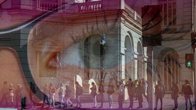 People are reflected in the window of an eyeglasses store as they wait outside the pension administration office to apply for an early withdrawal of a percentage of their government pensions in downtown Santiago, Chile. AP Photo