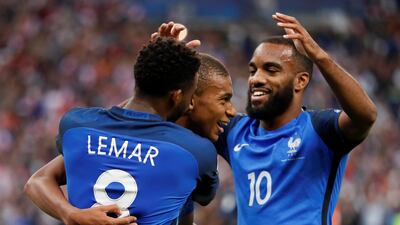 Thomas Lemar, left, was the subject of a €90 million bid from Arsenal; Kylian Mbappe, centre, has joined PSG on a season-long loan before completing a €180m move next summer; Alexandre Lacazette, right, moved to Arsenal over the summer for a €53m. Gonzalo Fuentes / Reuters