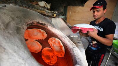 An Iraqi baker makes bread at a bakery in central Baghdad. AFP
