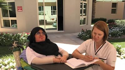 Abeer Thani Mohammed Almansoori with a therapist. Amana Healthcare