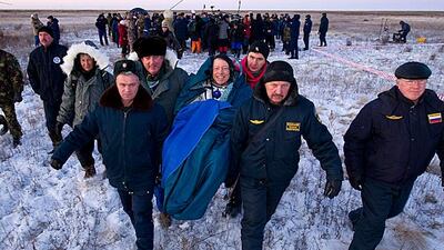 Nasa astronaut Mike Fossum smiles as his carried into a medical tent in Kazakhstan after returning to earth with Russian cosmonaut, Sergei Volkov and JAXA (Japan Aerospace Exploration Agency) astronaut Satoshi Furukawa after spending more than five months???