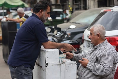 A currency exchange in Baghdad. Iraq's Central Bank devalued the dinar against the dollar on October 7, with the country facing a deepening crisis brought on by the war in the Middle East. AFP
