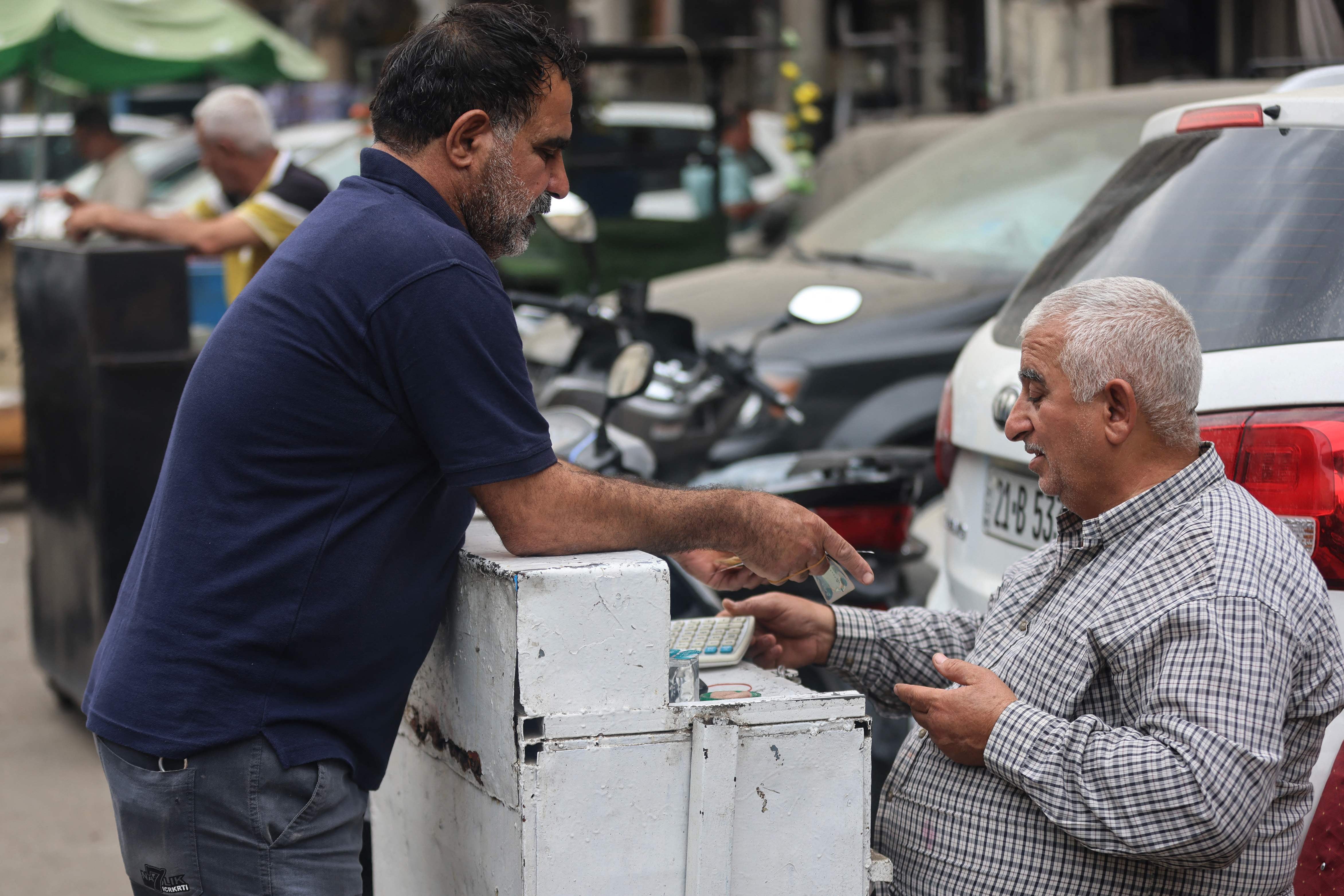 A currency exchange in Baghdad. Iraq's Central Bank devalued the dinar against the dollar on October 7, with the country facing a deepening crisis brought on by the war in the Middle East. AFP