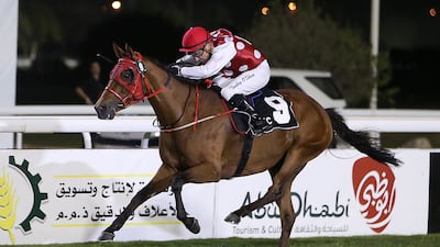 Tadhg O'Shea and Mahbooba race to victory in the Emirates Championship at Abu Dhabi Equestrian Club on Sunday. Pawan Singh / The National