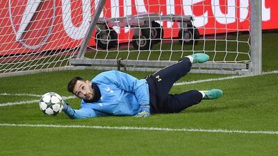 Tottenham keeper Hugo Lloris dives during training. Martin Meissner / AP Photo