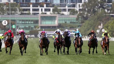 Jockey Michael Poy guides Alburq, left, to victory in the Candy Cane Lane Plate at Flemington Racecourse in Australia on Saturday, December 21. Getty