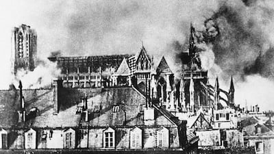 The Cathedral of Reims, France smokes after bombardment.