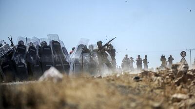 The state-run Anadolu Agency said Kurdish protesters threw stones at the security forces who prevented dozens of Kurdish onlookers from approaching the border. Bulent Kilic/AFP Photo