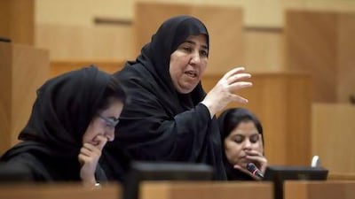 Fujairah FNC member Aisha Al Yammahi, also a school principal, makes her point on the need for teachers to be properly evaluated to the Minister of Education in yesterday's council session. Silvia Razgova / The National