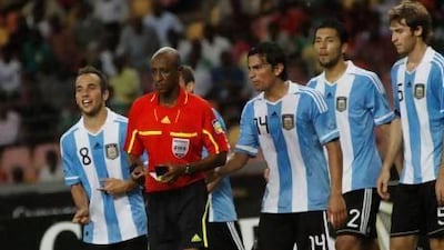 Ibrahim Chaibou, in red, a Fifa-registered referee, is surrounded by Argentina players after awarding a penalty against them during an international friendly against Nigeria in 2011. The official from Niger's questionable decisions prompted an investigation by Fifa and the Nigerian FA into the possibility the match had been fixed but no charges were ever made. Sunday Alamba / AP Photo