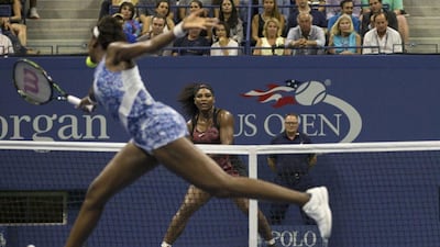 Venus Williams plays a shot to sister Serena during their quarter-final match at the US Open on Tuesday. Adrees Latif / Reuters