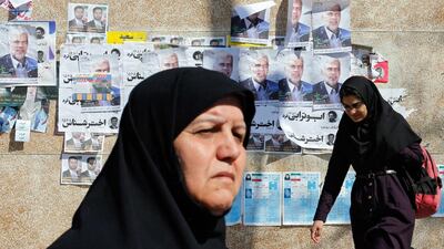 In Tehran, Iranian women walk past electoral posters for the upcoming parliamentary elections due to take place on February 26, 2016. Abedin Taherkenareh/EPA