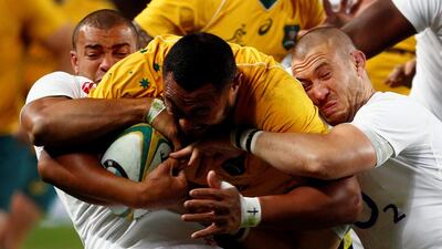 Australia’s Sekope Kepu is tackled England’s Jonathan Joseph, left, and Mike Brown during the first half. David Gray / Reuters