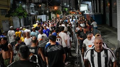 Fans line up to attend the funeral ceremony of Pele in Santos. AP