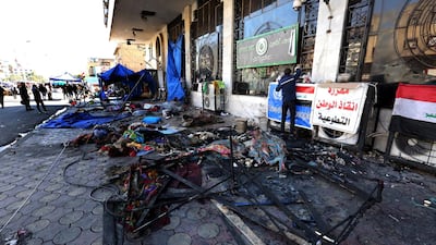 Iraqi protestesters inspect their tents which were burned out by anti-riot police forces in the previous day at the Al Tahrir square in central Baghdad, Iraq. EPA