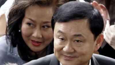 Thaksin Shinawatra and his wife Pojaman arriving at criminal court in Bangkok last month. He and his wife failed to report before a high court today.