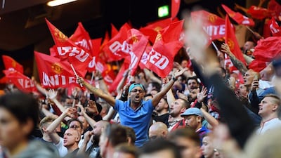 Manchester United fans wave flags on cheer on their team inside the Friends Arena. Georgi Licovski / EPA