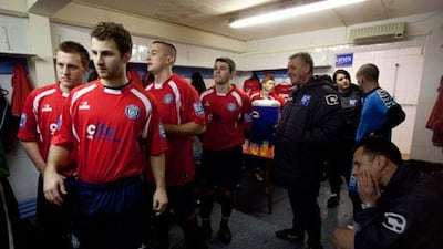 Hyde FC players get ready to step on to the pitch to play a game of football.
