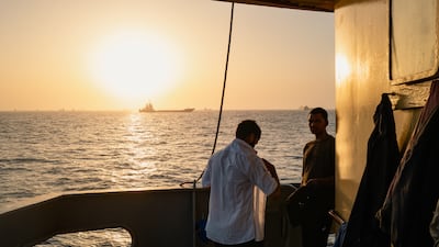 Sailors on a cargo vessel near Oman's Port Sultan Qaboos. Traffic at the Strait of Hormuz has improved, but safety concerns remain. Getty Images