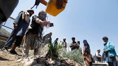 A man pours water on the grave of Afghan female journalist and political adviser Mina Mangal, a day after she was killed by unknown gunmen in downtown Kabul, Afghanistan, 12 May 2019. EPA