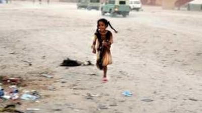 A Saharawi girl runs through the middle of the street in a Saharawi refugee camp in Algeria.