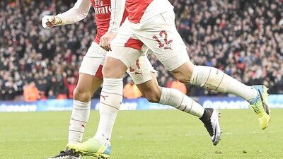 Arsenal's Alexis Sanchez celebrates his winning goal with teammate Olivier Giroud on the FA Cup on Saturday. Facundo Arrizabalaga / EPA