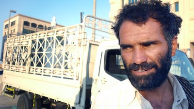 Freelance furniture remover Mohammed waits with his truck in the sun for anyone seeking to hire him. Delores Johnson / The National