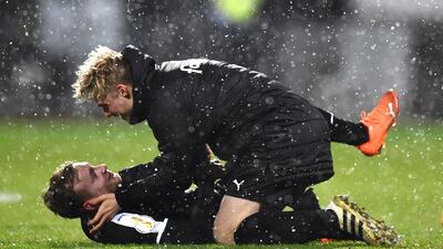 Holstein Kiel's Jannik Dehm celebrates with teammate after their shock DFB Cup win over Bayern. Getty