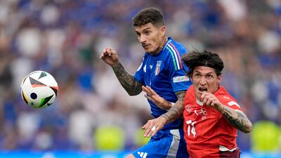 Italy's Giovanni Di Lorenzo, left, and Switzerland's Steven Zuber battle for the ball at the Olympiastadion in Berlin. PA