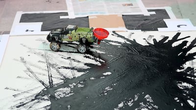 Artist Sharan Budhrani creates art using remote control cars that help him create despite the muscular dystrophy that limits his movements. Chris Whiteoak / The National