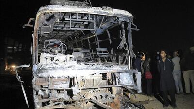 Pakistani security officials inspect the wreckage of a passenger bus after it collided with an oil tanker and burst into flames along the Super Highway near Karachi, Pakistan. Shahzaib Akber / EPA