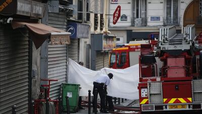 Firefighters work on a scene after a fire broke out early in the morning. Yoan Valat / EPA