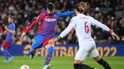 Sevilla's Nemanja Gudelj challenges Barcelona's Gerard Pique at the Camp Nou Stadium. AFP