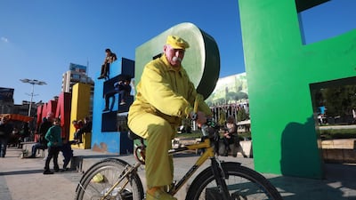 Abu Zakkour, Aleppo's so-called 'yellow man' rides his bicycle in the central Saadallah al-Jabiri square in the northern Syrian city. All photos by AFP