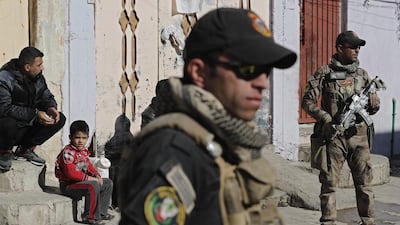 Iraqi special forces stand guard in a street, as ISIL fighters clash with government forces, in a northeastern district of the city of Mosul on November 24, 2016. Thomas Coex / Agence France-Presse