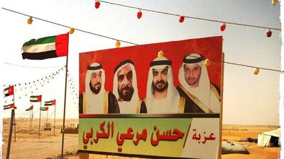 Day trip with friends to the Western Region and the Mazayin Dhafra Camel Festival, 220 kms west of Abu Dhabi on December 20, 2013. Sign with the UAE rulers, lights and flags. Picture taken with the Hipstamatic app for the iPhone. Liz Claus / The National