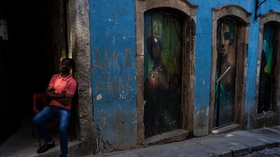 A man leans against a door frame in the Pelourinho neighbourhood of Salvador, Bahia State, Brazil. AP