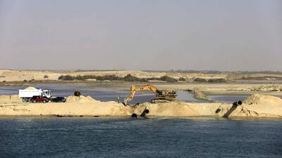 Bulldozers and trucks work on a new section of the New Suez Canal in Ismailia, Egypt. Hassan Ammar / AP Photo