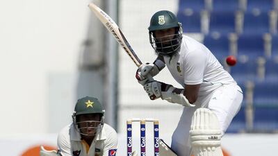 Hasim Amla, right, of South Africa bats as Pakistan's wicketkeeper Kamran Akmal watches on during their first Test at the Sheikh Zayed Cricket Stadium in Abu Dhabi on Monday. South Africa's paceman Mohammad Irfan took two early wickets to leave his team at 66-3 at lunch on the opening day of the first Test. Karim Sahib / AFP