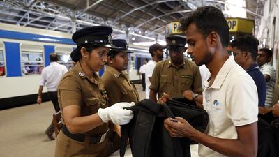A security personnel checks the bag of a passenger at Fort train station. EPA