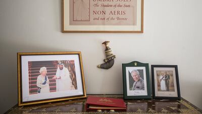 A traditional mandoos, or dowry chest, sits in the entrance to the residence alongside pictures of the UK and UAE royal families and a work of concrete poetry by the Scottish artist, Ian Hamilton Finlay. Mona Al Marzooqi / The National