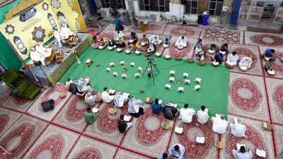 Men read at Al Qasim Mosque during the blessed month of Ramadan in Hilla, Iraq. Reuters