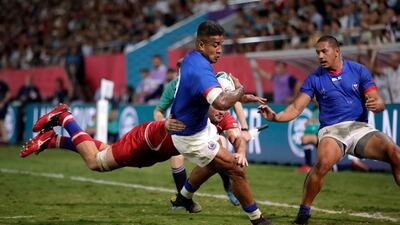 Samoa's Rey Lee-lo, centre, surges through to score a try. AP