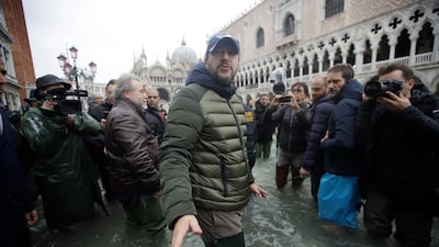 The League leader Matteo Salvini speaks to reporters as he walks in a flooded St. Mark's Square at Venice. AP Photo